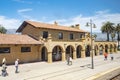 people wait for the pacific surfliner train at old mexican style Santa Barbara station