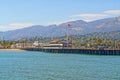 Santa Barbara wharf, ocean view, palm trees, mountains, and cloudy sky background