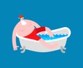 Santa in bath. Klaus is relaxing in bathtub. New year and christmas grandfather