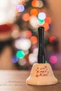 Santa bell with Christmas lights and children in the background Royalty Free Stock Photo