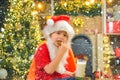 Santa boy child eating cookies and drinking milk. Santa boy in Santa hat. Royalty Free Stock Photo