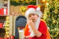 Santa boy child eating cookies and drinking milk. Santa boy in Santa hat. Royalty Free Stock Photo