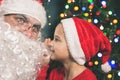 Santa and boy near the decorated Christmas tree. Wishes list Royalty Free Stock Photo