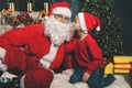 Santa and boy near the decorated Christmas tree. Wishes list Royalty Free Stock Photo