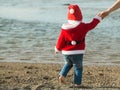 Santa boy at sand beach water Royalty Free Stock Photo