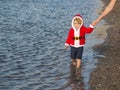 Santa boy at sand beach water Royalty Free Stock Photo