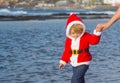 Santa boy at sand beach water Royalty Free Stock Photo