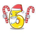 Santa with candy number six isolated on the mascot Royalty Free Stock Photo