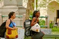 SANTA CLARA, CUBA - Apr 28, 2018: ourist Girls with Several Backpacks Walk Around the Main Square Looking for a Place