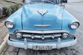 Front of old refurbished blue retro Chevrolet car. Close-up. Front view.