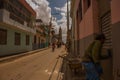 SANTA CLARA, CUBA: Street trader on the street in the revolution city Santa Clara Cuba. Colonial buildings