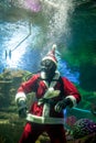 Santa Claus with aqualung under water