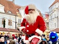 Santa claus arrive in the snowy city Greetings and present gifts for people on street at Holiday in Tallinn old town at New Year