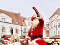 Santa claus arrive in the snowy city Greetings and present gifts for people on street at Holiday in Tallinn old town at New Year