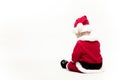 Santa Claus baby in red christmas clothes sits with his back isolated on white Royalty Free Stock Photo