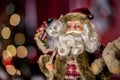 Santa Claus on the background of the Christmas or New Year tree, which leaves in bokeh. Royalty Free Stock Photo