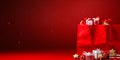 Santa claus bag full of gifts and decorations on red background, copy space. Merry Christmas shopping Royalty Free Stock Photo