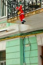 Santa Claus with a bag on his back, up the rope ladder Royalty Free Stock Photo