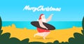 Santa claus on the beach holding surfboard christmas new year vacation concept seascape background horizontal full Royalty Free Stock Photo