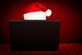 Santa Claus behind laptop