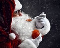 Santa Claus is trying to eat holding spoonful of red caviar fish salmon under snow. New year and Merry Christmas