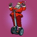 Santa Claus biker with Christmas gifts rides an electric scooter Royalty Free Stock Photo