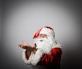 Santa Claus is blowing invisible snow Royalty Free Stock Photo