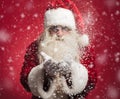 Santa claus blowing snow flakes out of his hands Royalty Free Stock Photo