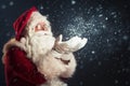 Santa Claus blowing snow of his hands Royalty Free Stock Photo