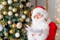 Santa Claus blows snow off his hands near the Christmas tree Royalty Free Stock Photo