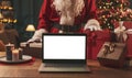 Santa Claus bringing Christmas, gifts and laptop Royalty Free Stock Photo