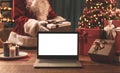 Santa Claus bringing Christmas, gifts and laptop Royalty Free Stock Photo