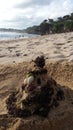 Santa Claus built from sand seaweed and stones by a javanese moslem on a beach in java indonesia christmas greetings postcard Royalty Free Stock Photo