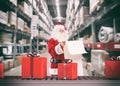 Santa Claus busy with the orders of Christmas gifts in a warehouse Royalty Free Stock Photo