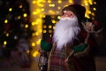 Santa Claus carrying big bag full of gifts, home near Christmas Tree Royalty Free Stock Photo