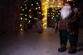 Santa Claus carrying big bag full of gifts, a home near Christmas Tree Royalty Free Stock Photo