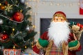 Santa Claus carrying big bag full of gifts, home near Christmas Tree Royalty Free Stock Photo