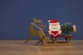 A Santa Claus is carrying a Christmas tree on a sled. Christmas and New Year concept Royalty Free Stock Photo