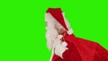 Santa Claus carrying his bag, looks at the camera and winks, Green Screen, stock footage