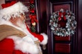 Santa Claus carrying large bag with present in night