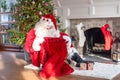 Santa Claus checking his bag for gifts Royalty Free Stock Photo