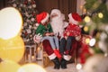 Santa Claus and children in room decorated for Christmas Royalty Free Stock Photo