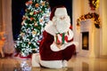 Santa Claus on Christmas eve. Presents under tree Royalty Free Stock Photo