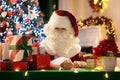 Santa Claus on Christmas eve. Presents under tree Royalty Free Stock Photo