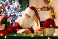Santa Claus on Christmas eve. Presents under tree Royalty Free Stock Photo
