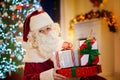 Santa Claus on Christmas eve. Presents under tree Royalty Free Stock Photo