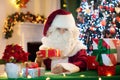 Santa Claus on Christmas eve. Presents under tree Royalty Free Stock Photo