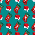 Santa Claus christmas red hat and christmas sock isolated on green background. Christmas seamless pattern Royalty Free Stock Photo