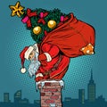 Santa Claus with a Christmas tree in a bag climbs the chimney Royalty Free Stock Photo