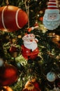 Santa Claus Christmas tree decoration ornament on a branch with lights on Royalty Free Stock Photo